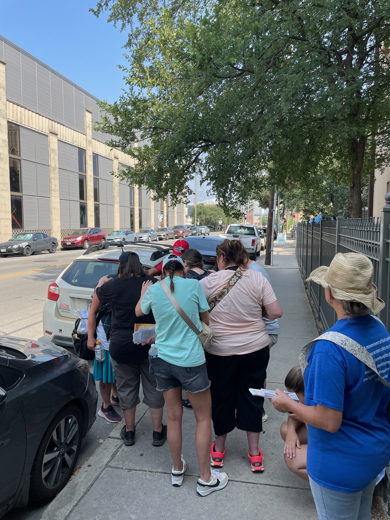Team members praying together during a mission outreach